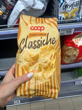 Montebelluna, Italy - October 9, 2025: A pack of Coop Classic double cooked potato chips in a store, showcasing the snack&rsquo;s crisp texture and packaging design.