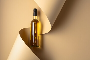 Bottle of white wine on a beige background.