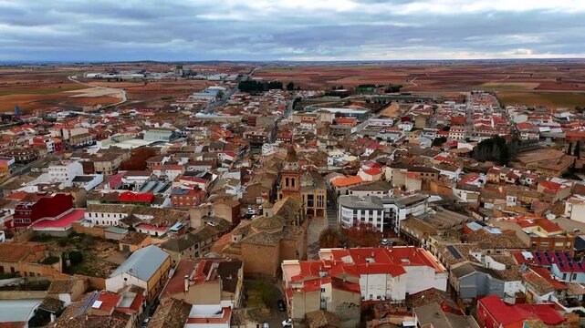 Wide drone view of Tarazona de la Mancha with rooftops streets and fields
