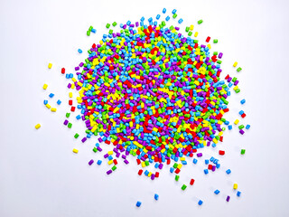 Masterbatch granules, industrial plastic manufacturing, colorful polymers arranged in rows, forming a rainbow-like shape, as a background for the design of a product catalog for an industrial plastic