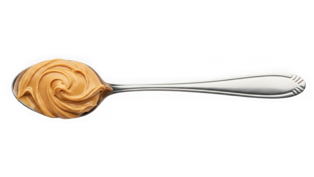 Creamy peanut butter with a perfect swirled texture on a shiny silver spoon, isolated on a clean background for use. isolated on transparent background