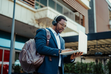 Black man working remotely researching online outdoors