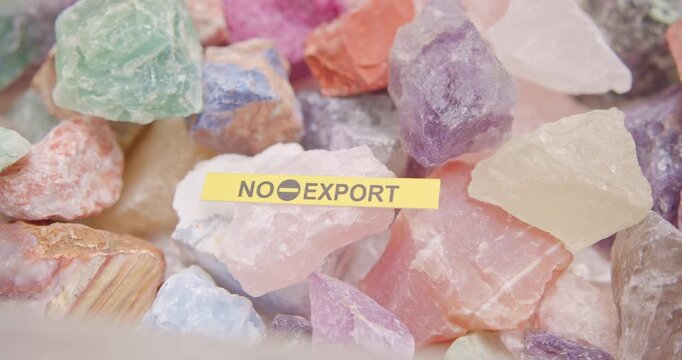 Critical raw materials and rare earth export restriction concept. A pile of mineral stone symbolizing US-China geopolitical tensions, trade sanctions, and the global battle for critical raw materials.