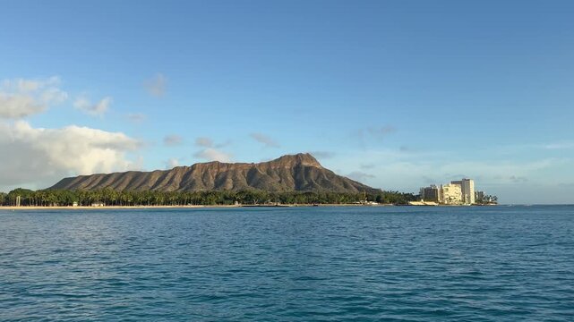 View of Diamond Head crater in Waikiki from sunset cruise boat in Honolulu on Oahu, Hawaii. 