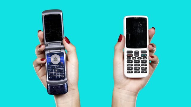 hand holding a sequence of old mobile phones 