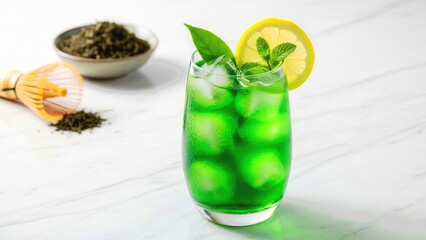 Fototapeta premium Refreshing iced matcha tea with lemon and mint garnish on marble