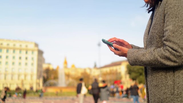 Traveler woman navigating barcelona with smartphone, enjoying urban exploration and cultural tourism at famous architectural landmark casa batll&oacute; on passeig de gr&agrave;cia
