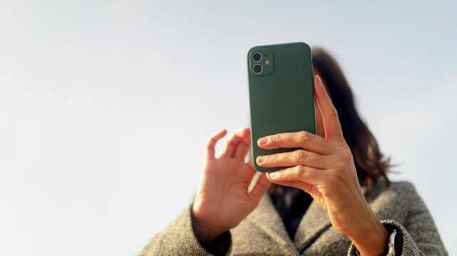 Traveler woman navigating barcelona with smartphone, enjoying urban exploration and cultural tourism at famous architectural landmark casa batll&oacute; on passeig de gr&agrave;cia