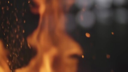 Dynamic close-up of vibrant orange flames and glowing sparks dancing in darkness. Fiery abstract background with warm embers. - Powered by Adobe