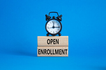 Open Enrollment symbol. Wooden blocks with words Open Enrollment. Beautiful blue background with...