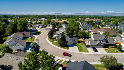 Small subdivision with homes and a red minivan