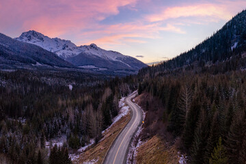 Winding Mountain Road Through Snowy Forest at Sunset in British Columbia, Canada Landscape
