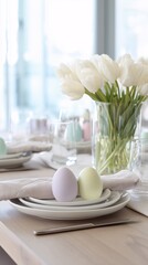 Eggs and flowers on a table in front of a vase.