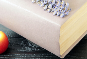 Concept: a book as a key to knowledge, a thick paper book on an old dark wooden table. Books as a...