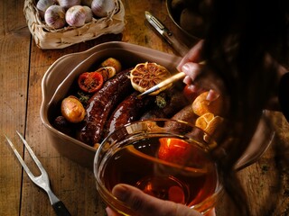 Juicy pork sausages are roasted to perfection with golden potato wedges and aromatic garlic. This comforting dish showcases traditional Romanian flavors for a satisfying winter meal