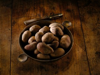 Savor the taste of authentic Romanian cuisine with juicy pork sausages and crispy potato wedges, seasoned with rosemary and garlic, perfect for a winter meal with family