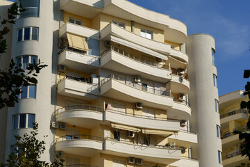 Mediterranean apartment complex with smooth facades and harmonized neutral colors. Renting an...