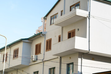 White modern apartment building with beige accents and spacious balconies. Great for buyers, renters, relocation seekers, and agencies offering Mediterranean-style coastal properties in Albania