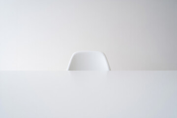 Simple white desk with chair for minimalist office workspace and clean modern interior design element with empty setting and background 150chr