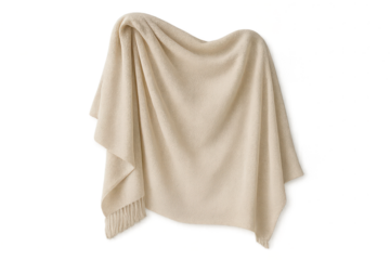 Soft beige cozy blanket with fringe draped on a transparent background
