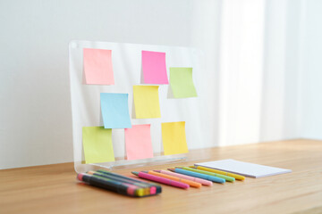 Brainstorming sticky notes on wood table near window office space for project management and creative team working ideas