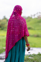 Indian woman dressed in purple sari at indian village