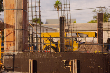 Active Construction Site With Signage, Rebar, and Wooden Forms in Early Stage Building. In St. Pete Beach, FL. Daylight highlights ongoing development, urban growth, and the sense of industry and prog