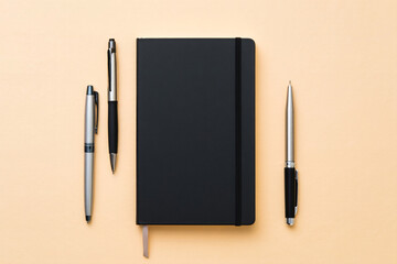 Black Notebook with Pens Flat Lay on Beige Background Office Stationery Supplies Writing Tools Workspace Business Concept 150 Char