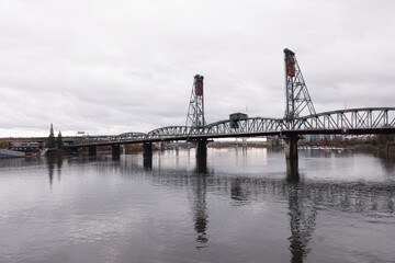 Fototapeta premium Portland, Oregon's landmark drawbridge, the Steel Bridge, which connects, the east and west sides of Portland, on a typically rainy day