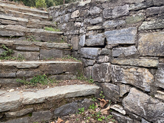 Rustic stone staircase and wall in outdoor garden setting