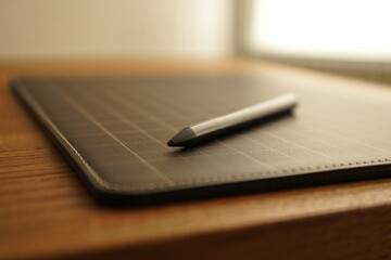 Digital Pencil and Dark Pad on Table for Designer Creative Tools with Close Up Photography in Light Colors and Clean Look Simple Design 150c