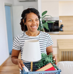 Young black woman girl moving into a new modern house, carrying boxes and arriving home. Happy, excited and smiling female student walking, entering and relocating after buying or renting, an apartmen