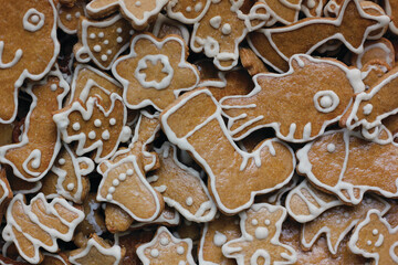 Christmas gingerbread cookies decorated with white icing in assorted holiday shapes, traditional homemade festive sweets baked for winter celebrations, close up food background full of detail