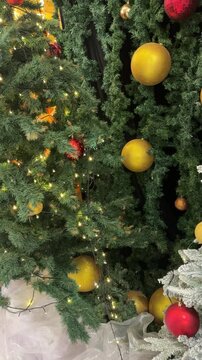 4k footage close up of lighted Christmas tree ornaments and decorations. Snow, mistletoe, baubles, and bell with Interactive sparkling christmas twinkle lights or icicle lights.