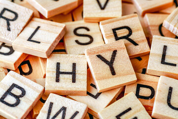 Alphabet letters on wooden block pieces, from above.Close up of Wooden letter cubes.Challenge and solution concept.Hobbies and leisure activities