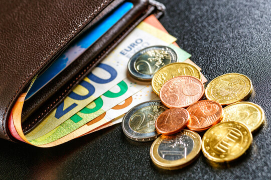 Various currencies in purse close-up.Open wallet with euro banknotes.British coins , pound sterling.Dollars cash and credit cards.Finance concept