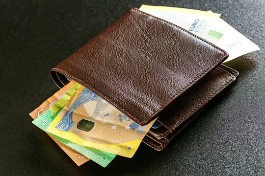 Various currencies in purse close-up.Open wallet with euro banknotes.British coins , pound sterling.Dollars cash and credit cards.Finance concept - Powered by Adobe