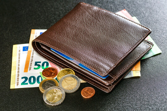 Various currencies in purse close-up.Open wallet with euro banknotes.British coins , pound sterling.Dollars cash and credit cards.Finance concept