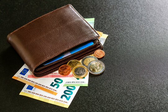 Various currencies in purse close-up.Open wallet with euro banknotes.British coins , pound sterling.Dollars cash and credit cards.Finance concept