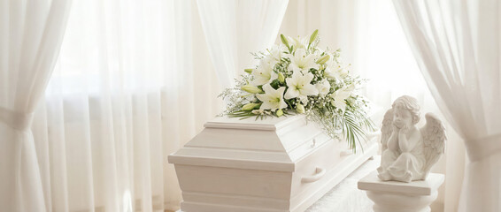 Serene white casket adorned with flowers in a peaceful setting  