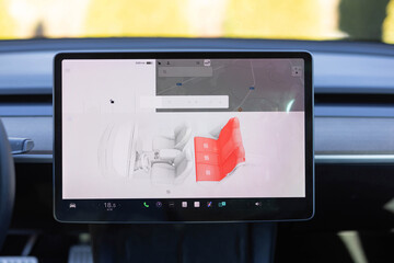 Heated seat dashboard in a car. Steering wheel heating button in the car. Switching ON heated seats of car by pressing the buttons. Electric car control panel with steering wheel and seat heating