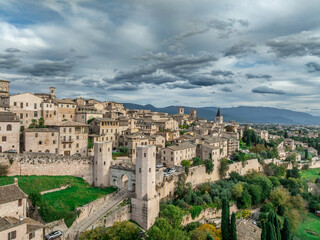 Obraz premium Aerial view of Spello enclosed in a circuit of medieval walls built on Roman foundations, Porta Venere or Venus gate with flanking towers