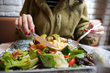 young woman eating salad