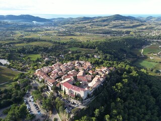 Fototapeta premium Aerial drone view of Le Castellet medieval village and surrounding green fields