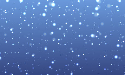Falling bright white snow particles or bokeh effect against a deep blue gradient winter background