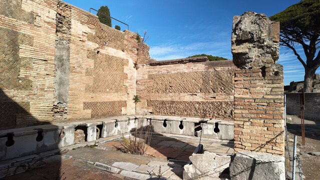 Ostia Antica, Rome - November 30, 2025, public toilets, the public restrooms of the ancient Romans, in the large archaeological park of Ostia Antica.