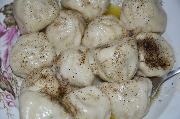 Khinkali sprinkled with ground pepper.