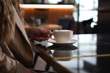 woman drinking coffee in cafe