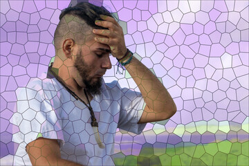 Young adult male with distressed expression holding forehead in motion-blurred background,