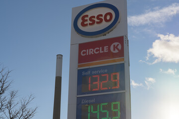 Fototapeta premium pylon street sign and price display of Esso, a gas station chain, located here at 829 Lake Shore Blvd, Toronto